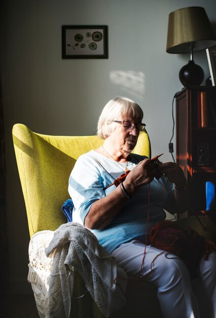 Ältere Frau, die zu Hause strickt