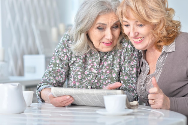 Ältere Frauen, die eine Zeitung lesen