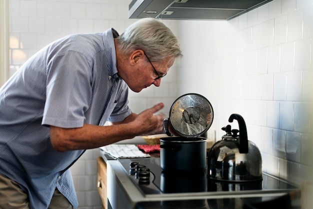 Älterer Mann, der Nahrungsmittelküche kocht