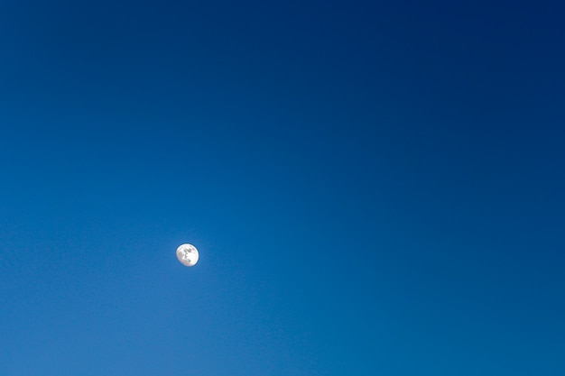 Lua iluminada em um céu azul escuro sem nuvens, natureza, paisagem