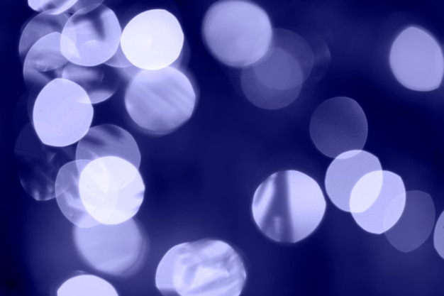 Luces de Navidad abstractas borrosas en color de moda del año 2022 Muy cerca de Peri. Desenfoque de luces bokeh, fondo defocused guirnalda de vacaciones. Bokeh festivo. Orientación horizontal.