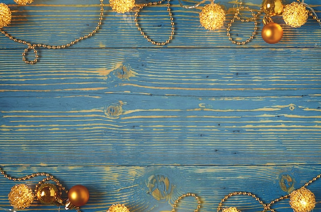 Luces de Navidad y bolas sobre un fondo de madera azul