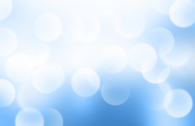 Luces o bokeh borroso en un fondo de gradiente azul