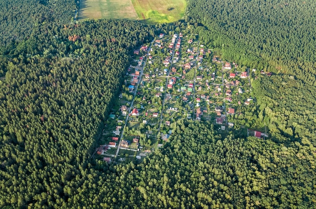 Luftansicht der Sommerhäuser des Wohngebiets im Wald von oben, Landimmobilien und kleines Datscha-Dorf in der Ukraine