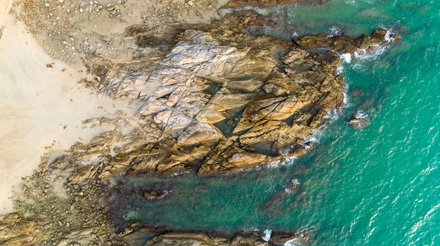 Luftaufnahme-Brummen schoss vom szenischen Meerblick weg vom Strand in Phuket Thailand mit der Welle, die auf den Felsen zusammenstößt