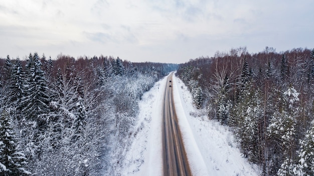 Luftaufnahme der Landstraße, die durch die schönen schneebedeckten Landschaften führt.