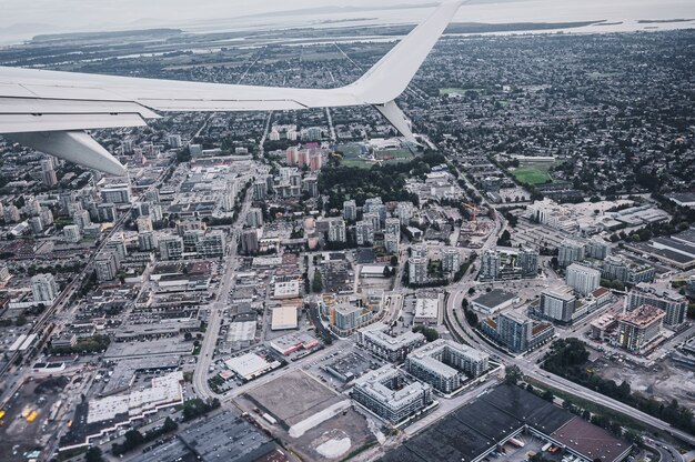 Foto luftaufnahme des flugzeugflügels auf den verkehr in der überfüllten stadt vancouver, kanada