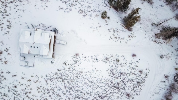 Luftaufnahme des im Winter mit Schnee bedeckten Berghauses.