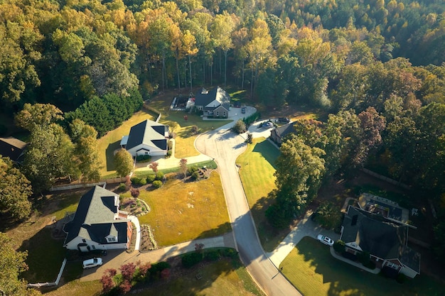 Luftbild von neuen Einfamilienhäusern zwischen gelben Bäumen im Vorortgebiet von South Carolina in der Herbstsaison Immobilienentwicklung in amerikanischen Vororten