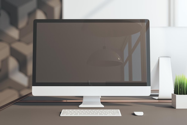 Lugar de trabajo de oficina contemporáneo y computadora con pantalla en blanco