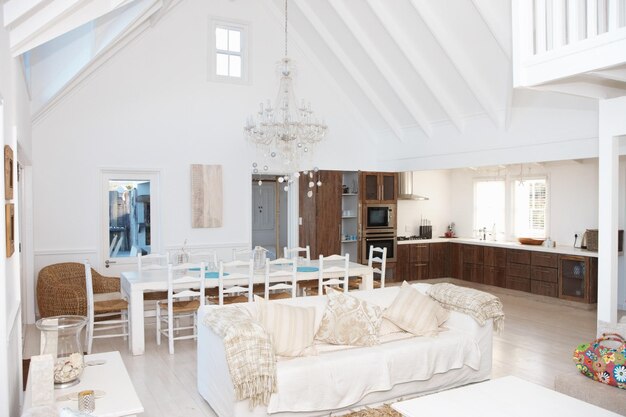 Lujosa sala de estar con cocina y mesa de comedor al fondo Interior de una espaciosa y moderna sala de estar con cocina al fondo