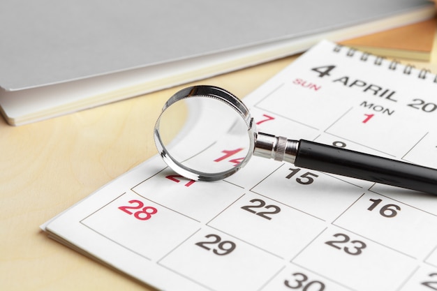 Lupa e calendário, conceito em negócios e reuniões