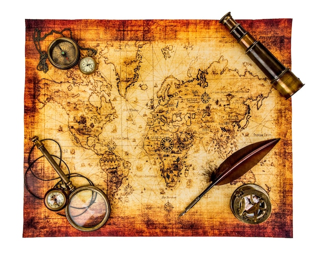 Foto lupa vintage, bússola, caneta de pena de ganso, luneta e um relógio de bolso deitado em um mapa antigo isolado em branco.