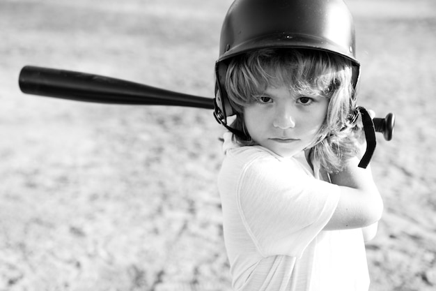 Lustiges Kind, das bei einem Baseballspiel schlägt. Kinderporträt hautnah.