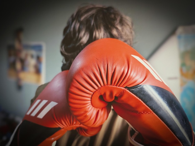 Luvas de boxe vermelhas nas mãos de pessoas prontas para a ação