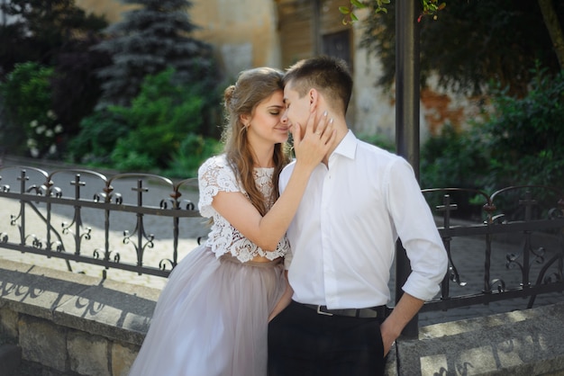 Luxus-Hochzeitspaar, das das Umarmen und Küssen im sonnigen Licht umarmt. wunderschöne Braut und stilvoller Bräutigam im sinnlichen zarten emotionalen Moment.