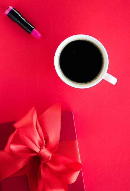 Luxus-Schönheitsgeschenkbox und Kaffee auf rotem Flatlay