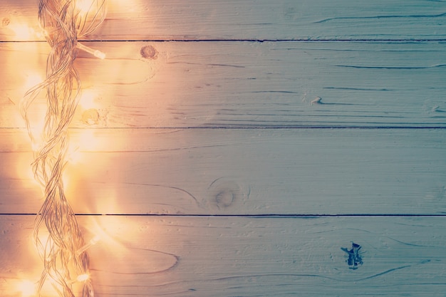 Luz de natal e decoração de natal em fundo de madeira branca com espaço de cópia.