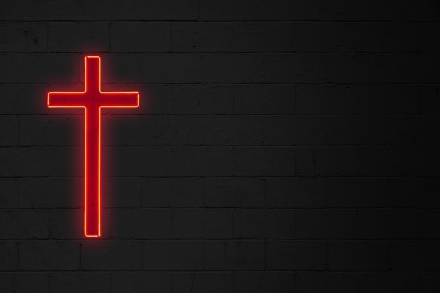 Luz de neón con forma de cruz cristiana roja pegada al costado de una pared de ladrillos