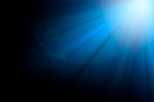 Foto luz de rayos azules y bokeh sobre fondo negro para el diseño de superposición.