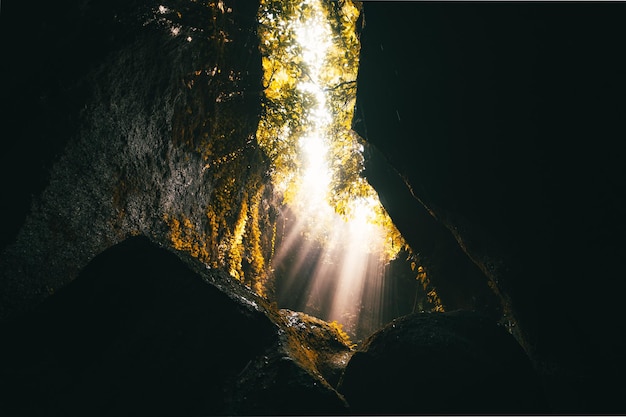 Foto la luz del sol fluye a través de las rocas en el agua