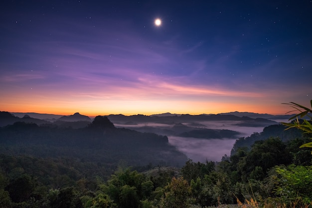 Luz solar ponto de vista sobre a montanha com a lua ao amanhecer