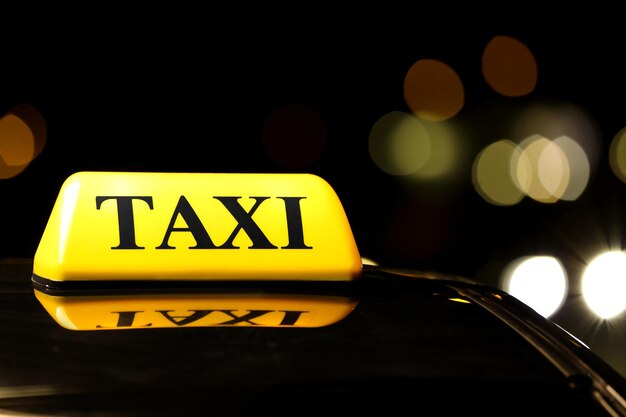 Señal de luz amarilla del coche de taxi en la calle oscura por la