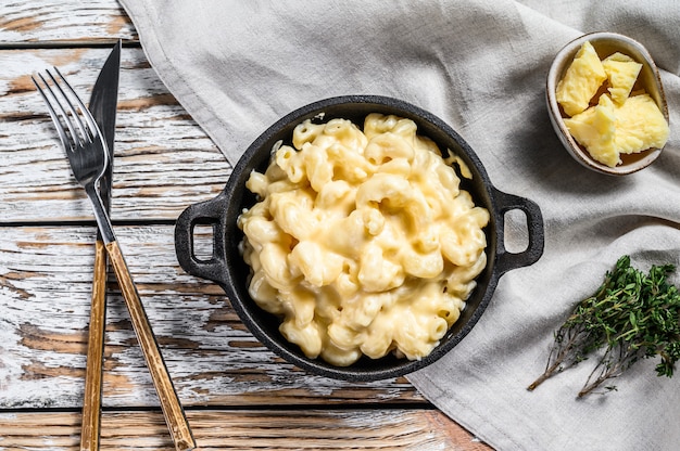 Mac y queso americano, pasta de macarrones con salsa de queso. Fondo de madera blanca Vista superior