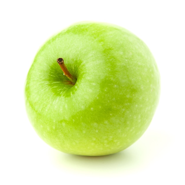 Foto maçã verde sobre uma superfície branca com uma sombra.
