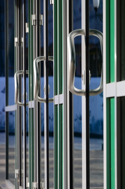 Maçaneta da porta do cromo e vidro da fachada de escritório de alumínio moderno