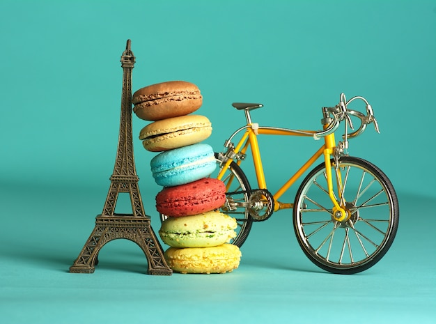 Macarons de diferentes sabores recarregados na torre Eiffel e uma bicicleta