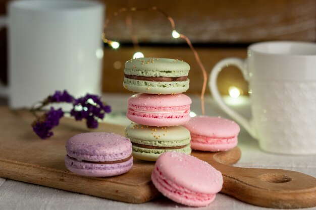 Macarons y taza de café en la mesa de madera