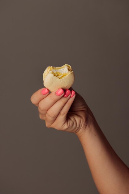 Macaroons franceses nas mãos da mulher