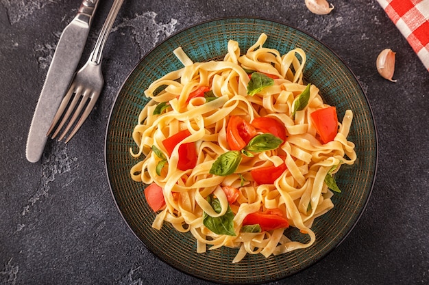 Macarrão com molho de tomate servido com manjericão