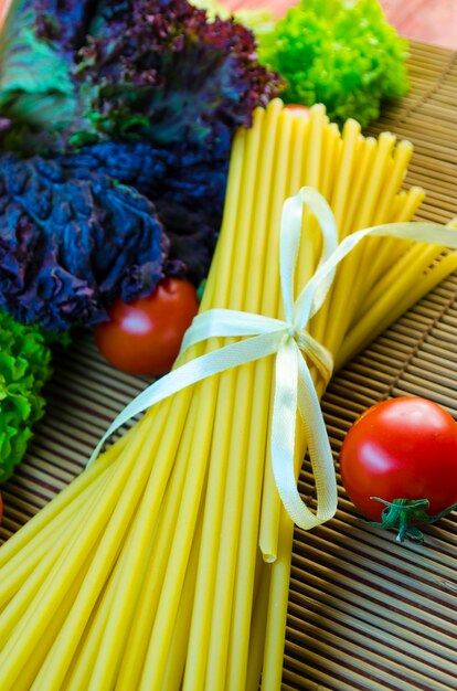 Macarrão e vegetais crus e longos na mesa