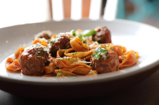 Macarrão espaguete com almôndegas de carne e molho de tomate em fundo de madeira. comida italiana