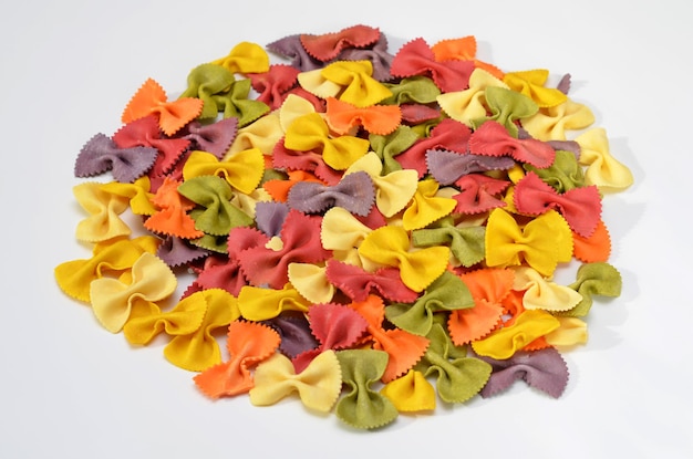 Macarrão farfalle colorido com extratos naturais isolados no fundo branco