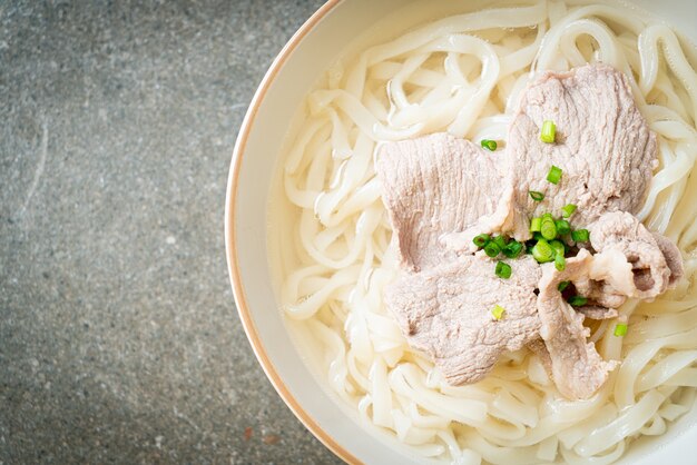 Foto macarrão udon ramen caseiro com carne de porco em sopa clara