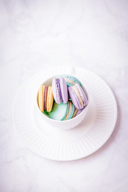 Macarrones de colores dulces en mármol blanco