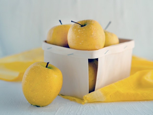 Maçãs amarelas na cesta em fundo branco Imagem simbólica Conceito de nutrição saudável