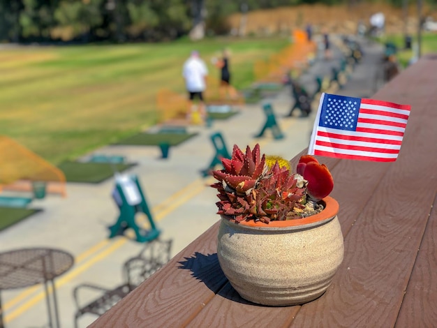 Maceta patriótica con banderas americanas y golfista en el fondo Decoración de la bandera americana