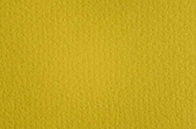 Foto macro fotografia de papel amarelo, textura irregular de papel de fundo detalhado. espaço de cópia em branco