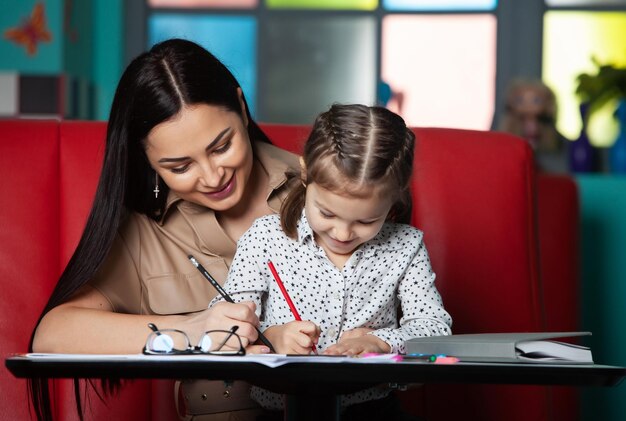 Madre ayudando a su hija con la tarea