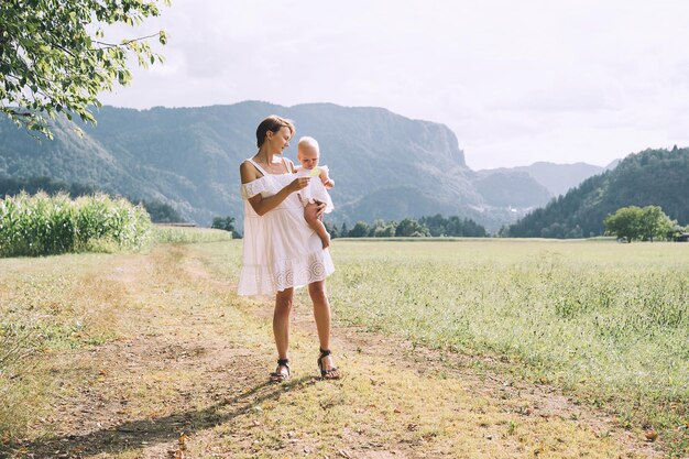 Madre y bebé al aire libre Familia en la naturaleza Mujer amorosa con niño en el campo Foto de paternidad natural licencia de maternidad Tema de cero desperdicio moda lenta y vida consciente estilo de vida ecológico