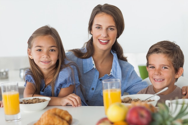 Madre desayunando con sus hijos