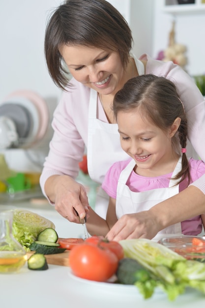 Madre e hija cocinando la cena en la cocina