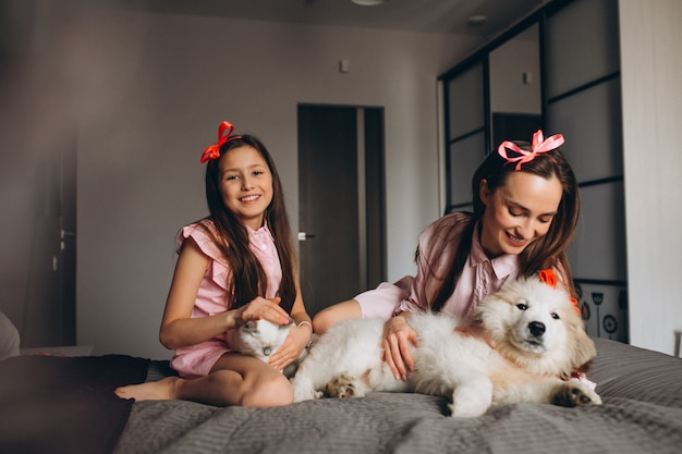 Madre e hija con gatito y perro