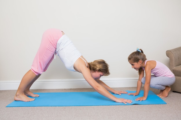 Madre e hija haciendo yoga