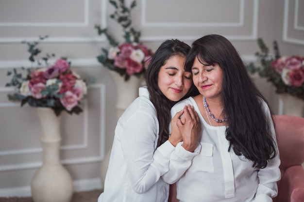 Madre e hija mexicana abrazándose en el día de la madre