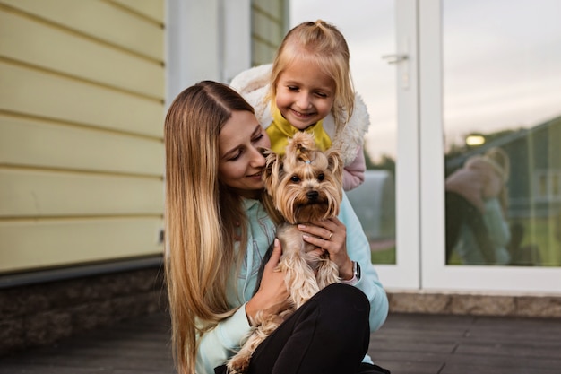 Madre e hija mirando al perro